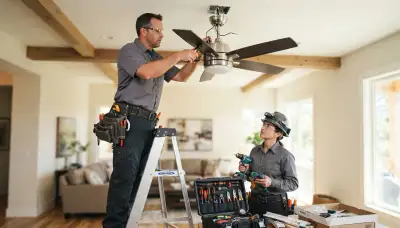 Electrician installing a ceiling fan in a Spokane, WA home