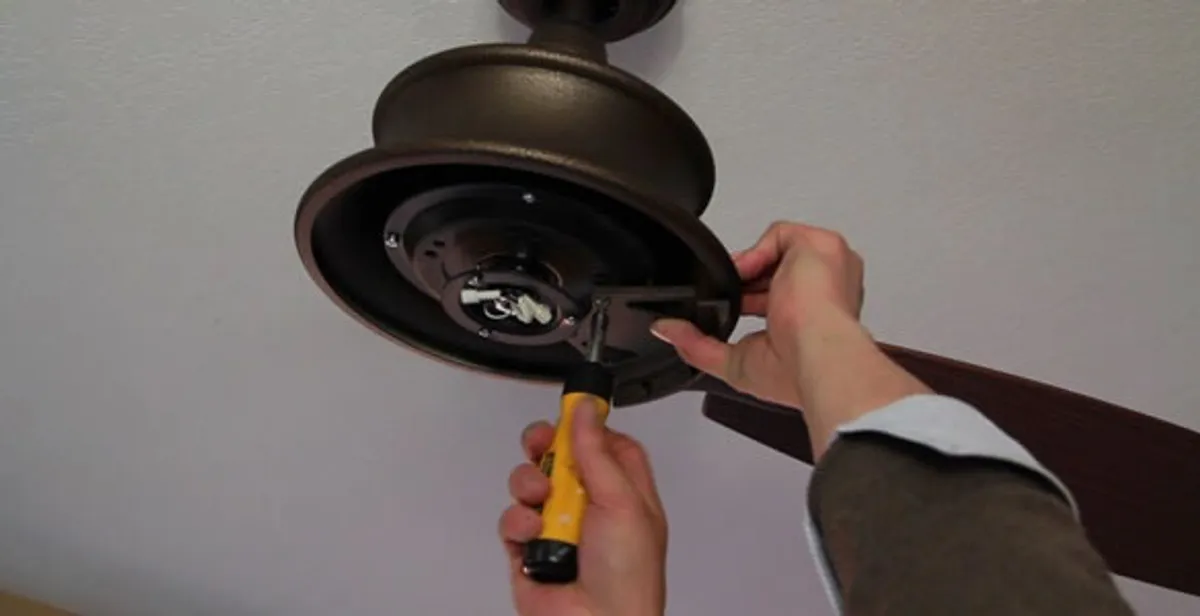 Electrician installing ceiling fan mounting bracket and fixture in Spokane, WA