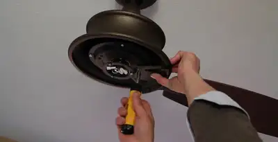 Electrician installing ceiling fan mounting bracket and fixture in Spokane, WA