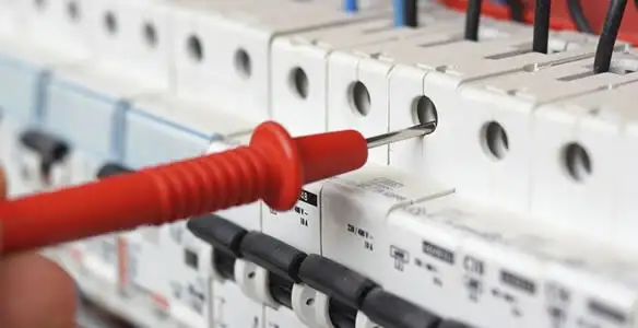 Electrical contractor testing circuit breakers during electrical repair in Otis Orchards, WA
