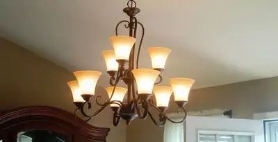 Classic ceiling chandelier installation with warm lighting in Spokane, WA