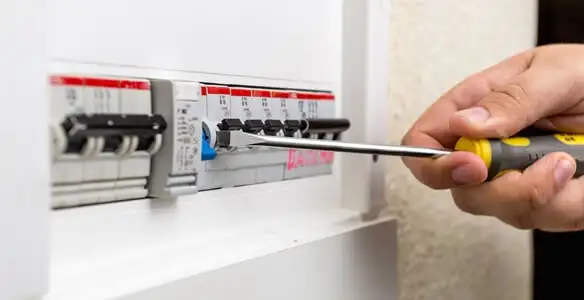 electrical panel upgrade service showing technician adjusting circuit breakers during system upgrade in Spokane, WA