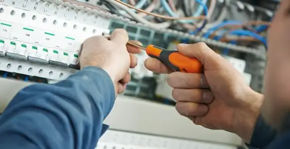 electrical service showing licensed electrician performing electrical panel maintenance and adjustments in Spokane, WA