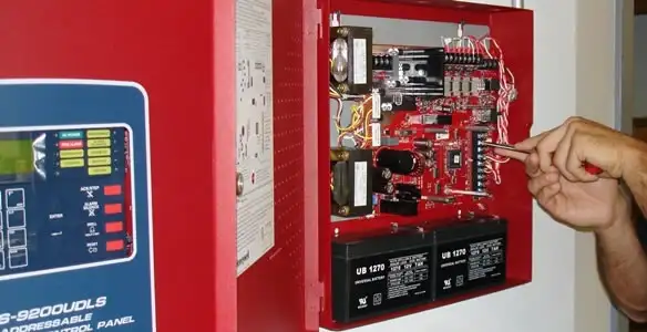 fire alarm installation service showing technician configuring fire alarm control panel in Spokane, WA