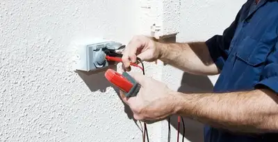 Electrician performing home electrical outlet and wiring inspection in Spokane, WA