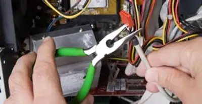 Licensed electrical contractor performing electrical repair with tools in Medical Lake, WA