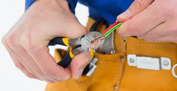licensed electrician securing electrical wiring with professional tools during service work in Spokane, WA
