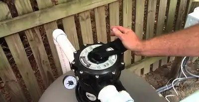 pool pumps service showing professional adjustment of pool pump control system in Spokane, WA