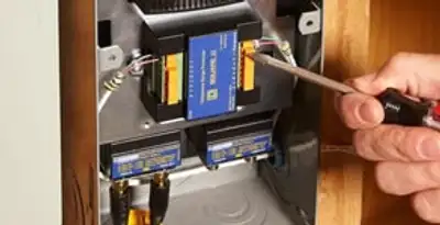 Whole home surge protection device being installed by a licensed electrician to protect electrical systems in Spokane, WA